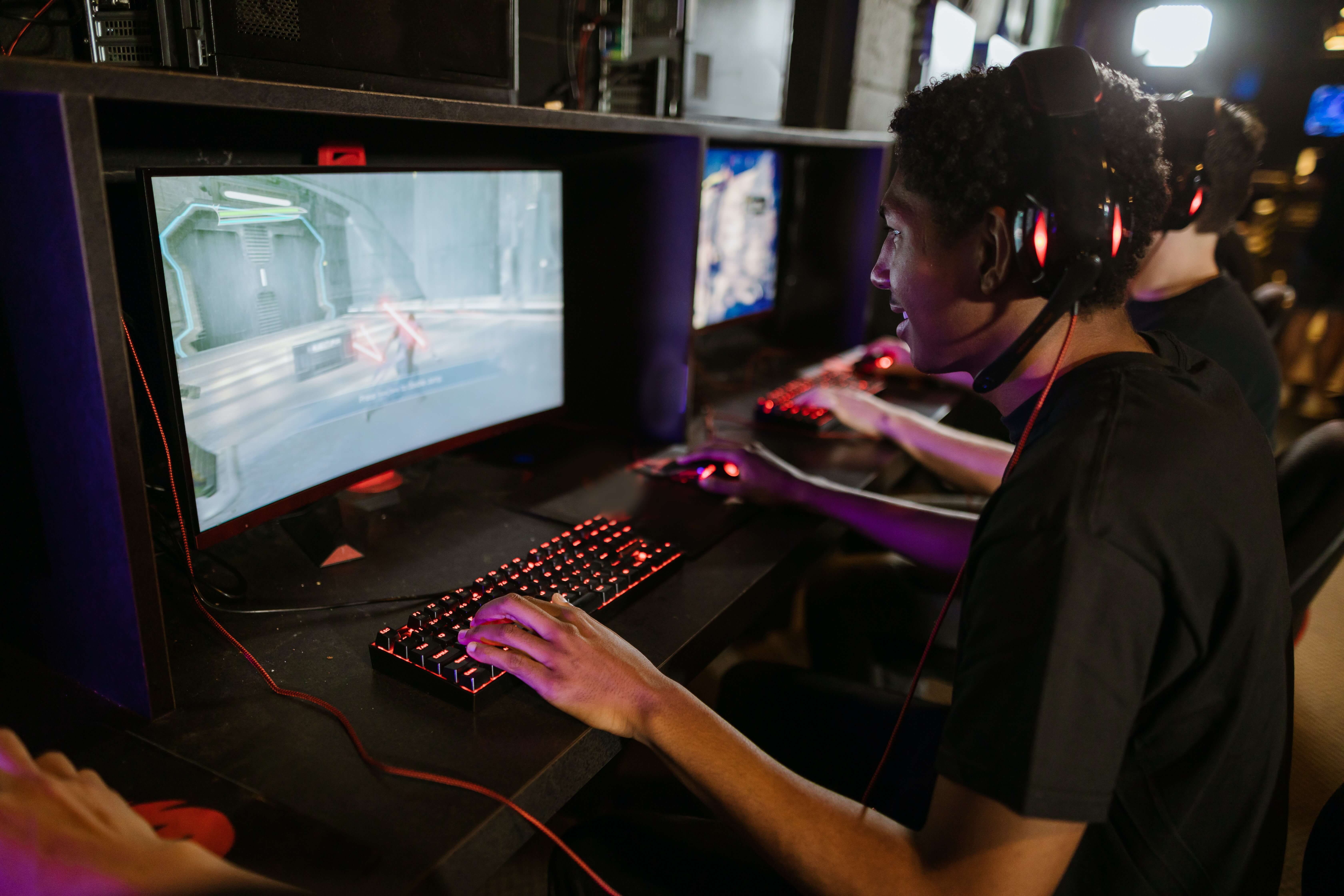 People playing video games in an internet cafe